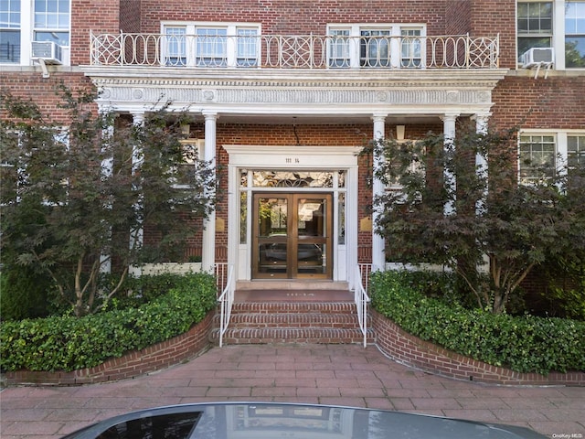 entrance to property with a balcony and french doors