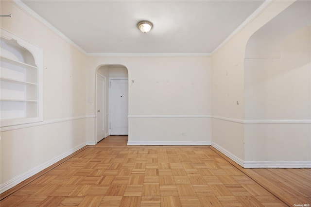 empty room with light parquet floors and ornamental molding