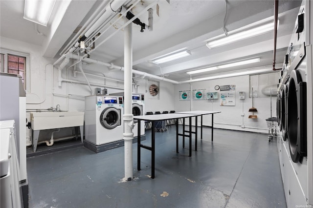 laundry room featuring sink, washing machine and dryer, and stacked washer / dryer