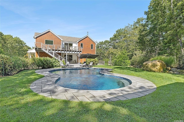 view of pool featuring a patio, a yard, and a deck