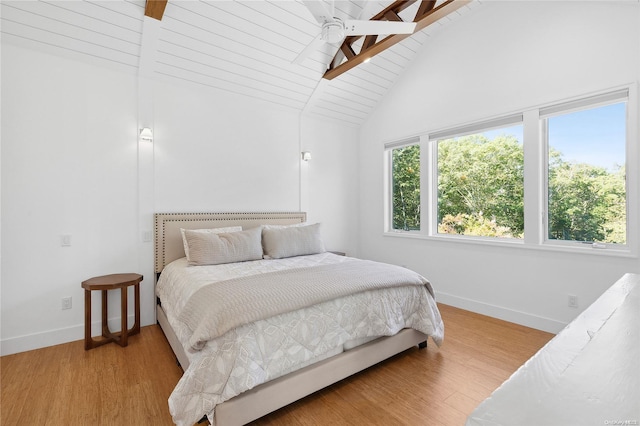 bedroom featuring vaulted ceiling with beams, ceiling fan, light hardwood / wood-style flooring, and wood ceiling