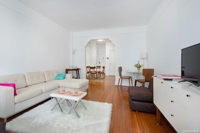 living room with hardwood / wood-style floors and ornamental molding