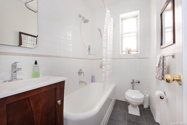 full bathroom featuring tile patterned floors, vanity, shower / tub combo with curtain, tile walls, and toilet