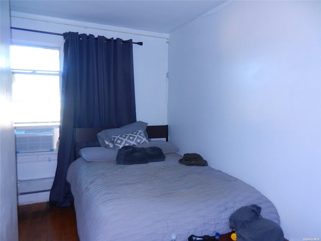 bedroom featuring hardwood / wood-style flooring and cooling unit