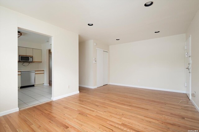 unfurnished room with light wood-type flooring