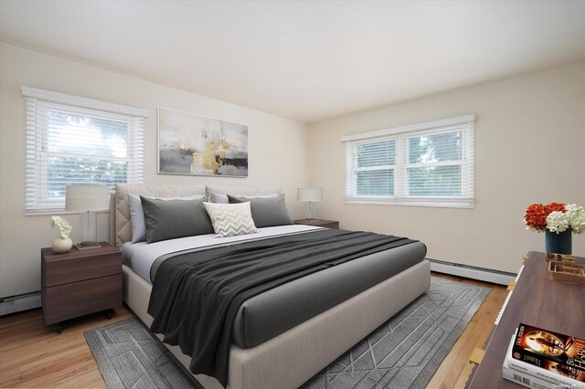 bedroom featuring hardwood / wood-style floors and a baseboard radiator