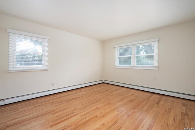 unfurnished room with light wood-type flooring