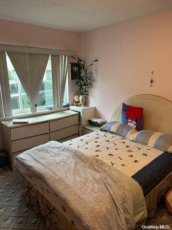 carpeted bedroom with a textured ceiling