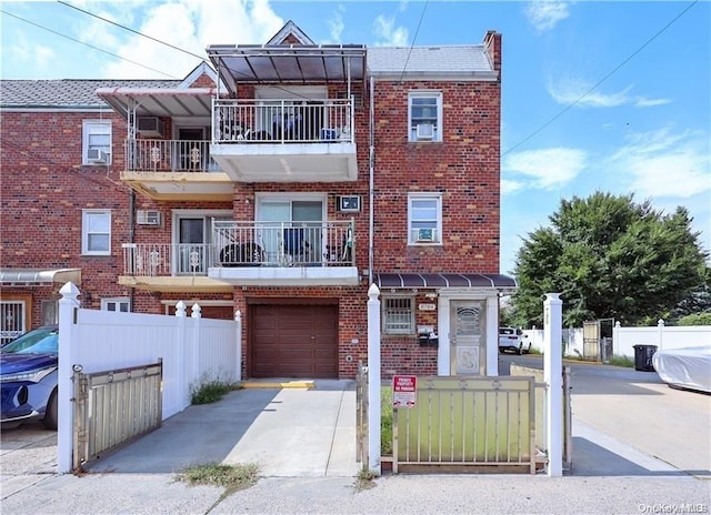 view of property featuring a balcony and a garage