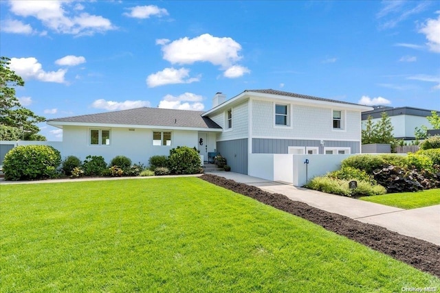 view of front of house featuring a garage and a front lawn