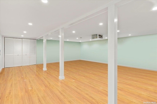 basement with light hardwood / wood-style floors