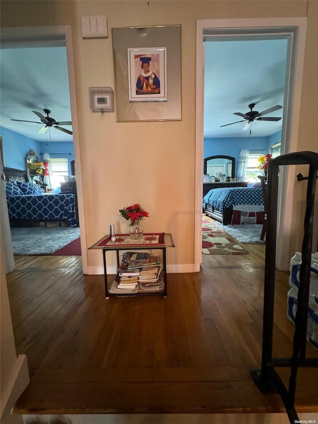 hallway with hardwood / wood-style flooring