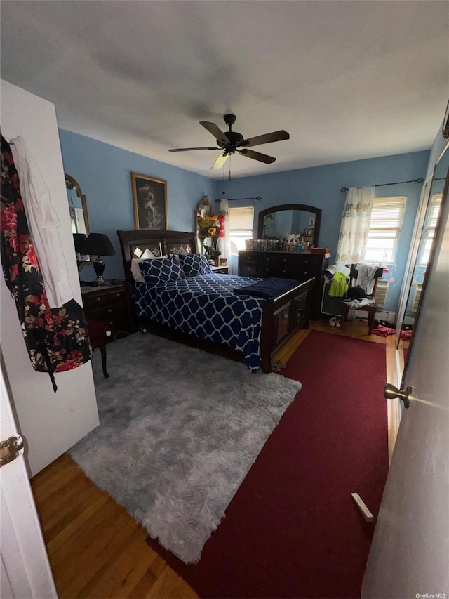 bedroom featuring hardwood / wood-style floors and ceiling fan