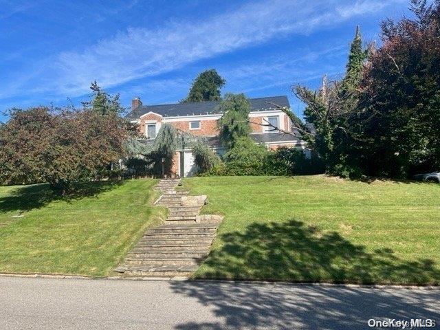 obstructed view of property with a front yard