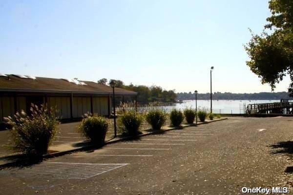 view of parking / parking lot with a water view