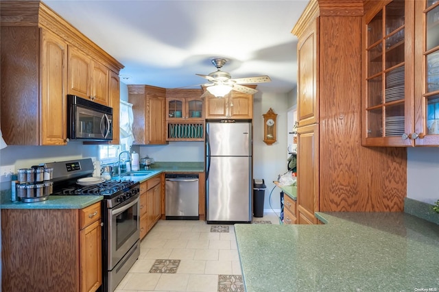 kitchen featuring ceiling fan, sink, light tile patterned floors, and appliances with stainless steel finishes