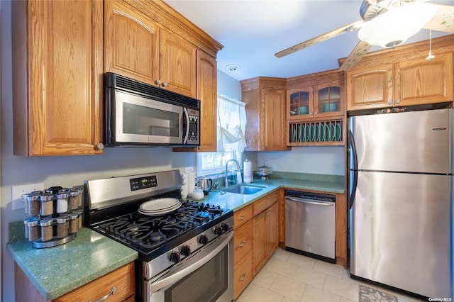 kitchen featuring ceiling fan, sink, light tile patterned floors, and stainless steel appliances