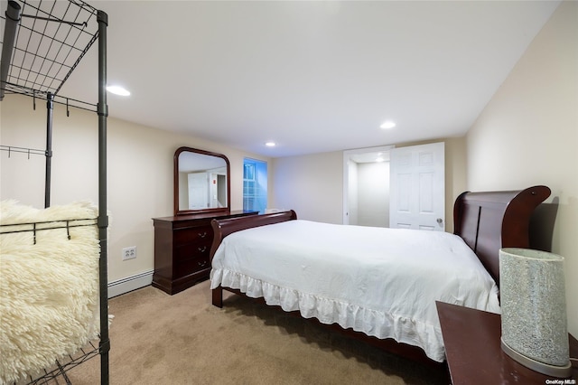 bedroom with baseboard heating and light carpet