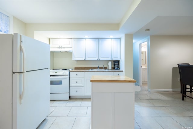 kitchen featuring white cabinets, light tile patterned floors, white appliances, and sink