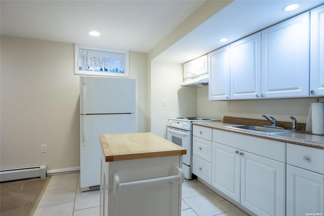 kitchen featuring white appliances, baseboard heating, sink, light tile patterned floors, and white cabinets