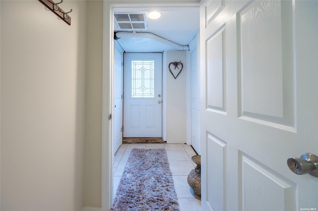 doorway with light tile patterned floors