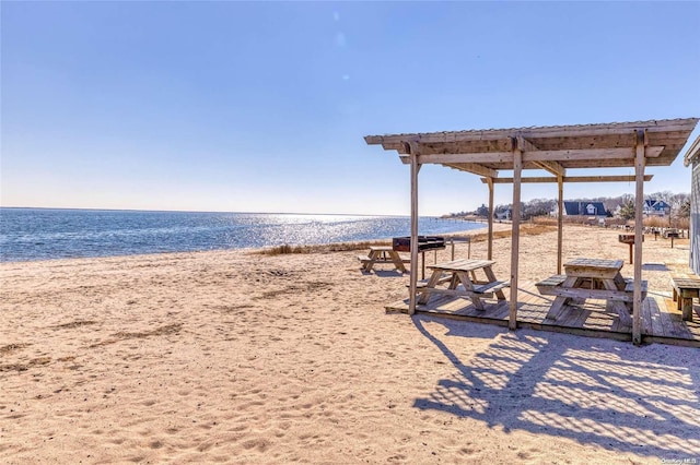 exterior space featuring a water view and a view of the beach