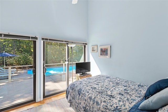 bedroom featuring access to outside, ceiling fan, and light hardwood / wood-style flooring