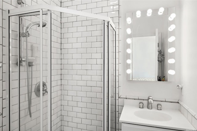 bathroom with vanity and a shower with shower door