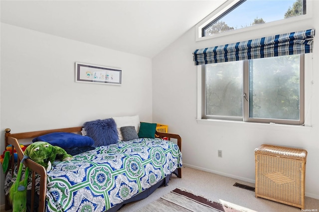 bedroom with carpet floors and lofted ceiling