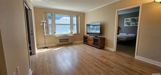 unfurnished living room with light hardwood / wood-style floors, heating unit, and ornamental molding