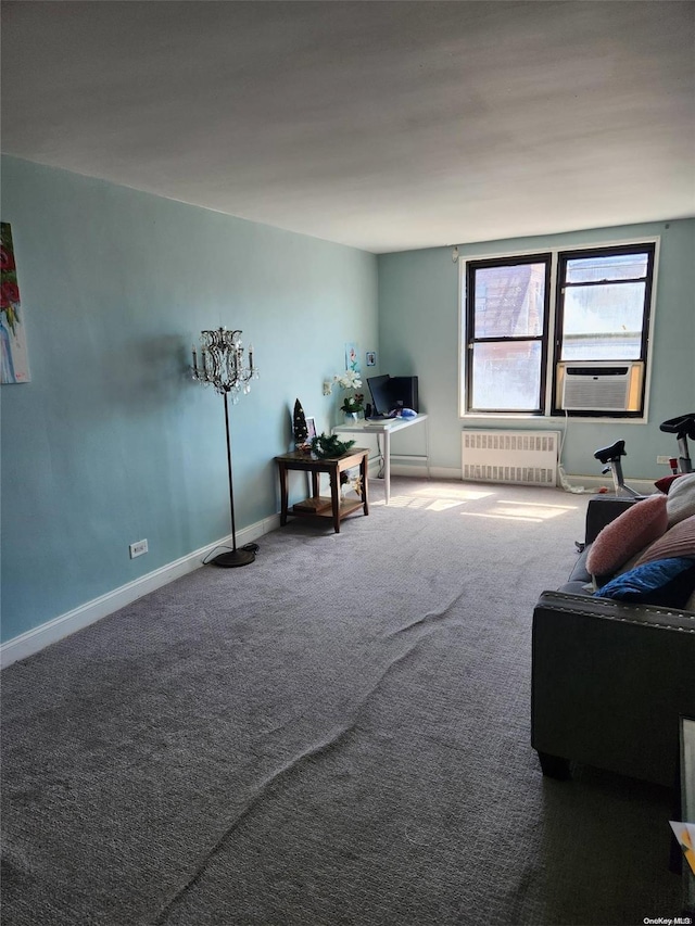 unfurnished living room featuring radiator heating unit, carpet floors, and cooling unit