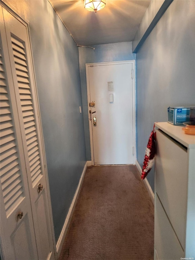 doorway featuring dark colored carpet