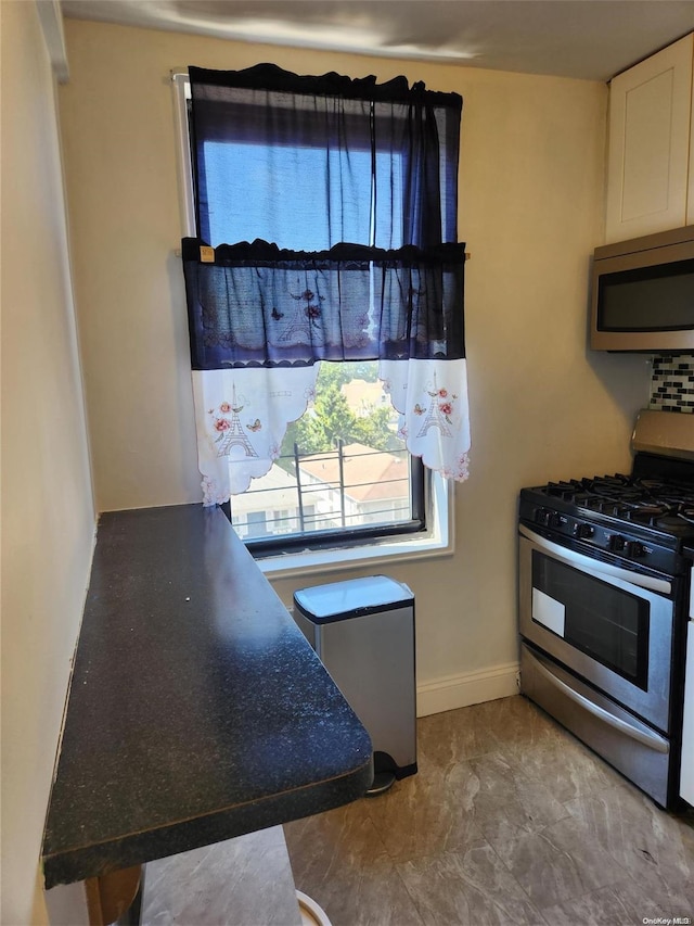 kitchen with white cabinetry and stainless steel appliances