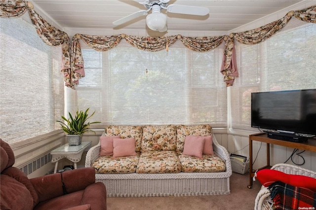 living room with carpet, radiator, crown molding, and ceiling fan