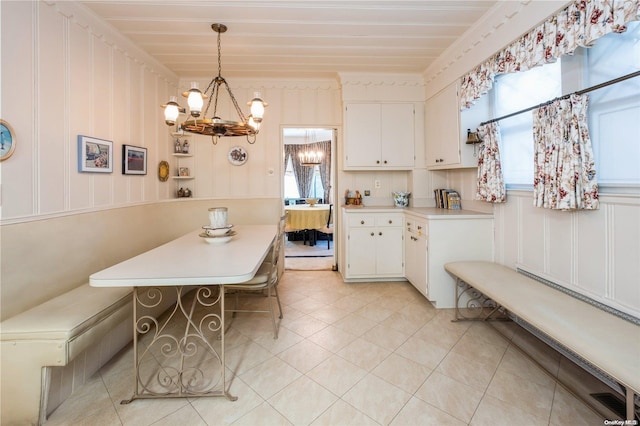 kitchen with white cabinets, plenty of natural light, and hanging light fixtures