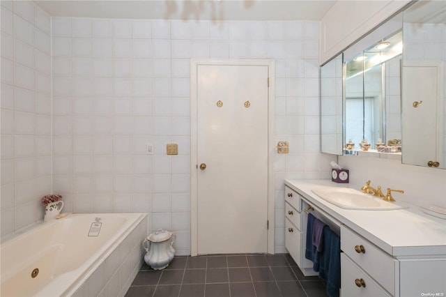 bathroom with vanity, tile patterned floors, tile walls, and tiled tub