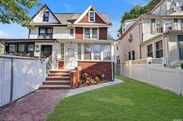 view of front of home featuring a sunroom and a front lawn