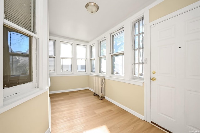 unfurnished sunroom with radiator