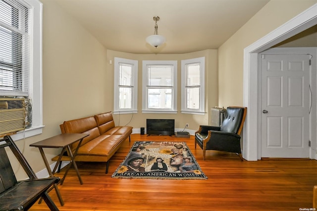 sitting room with radiator heating unit, hardwood / wood-style flooring, and plenty of natural light