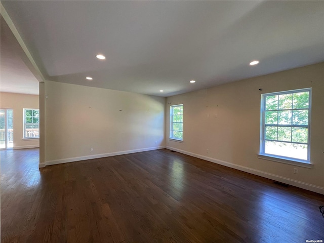 empty room with dark hardwood / wood-style flooring