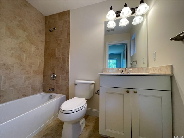 full bathroom featuring tiled shower / bath, tile patterned flooring, vanity, and toilet