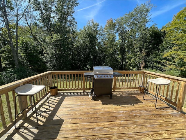 wooden deck featuring area for grilling