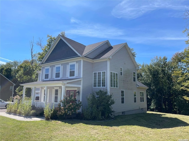 view of front of property featuring covered porch and a front lawn