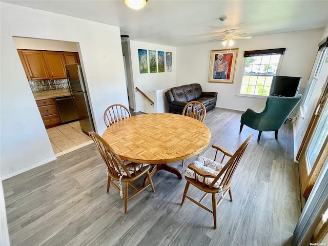 dining room featuring ceiling fan and light wood-type flooring