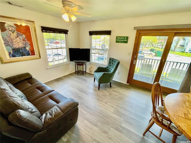 living room featuring ceiling fan and wood-type flooring