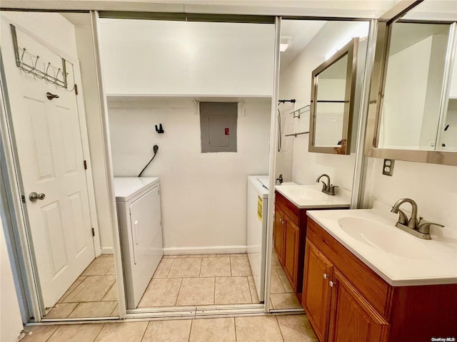 bathroom with tile patterned flooring, vanity, electric panel, and washing machine and clothes dryer