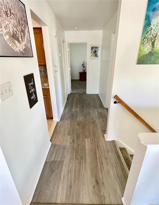 hallway with hardwood / wood-style flooring