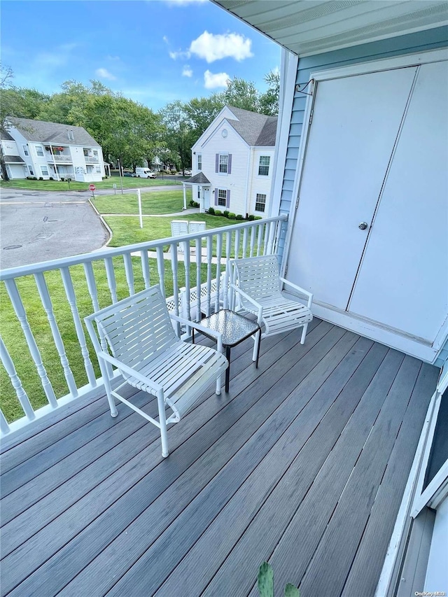 wooden terrace with a lawn