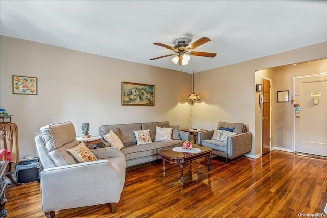 living room with ceiling fan and dark hardwood / wood-style flooring