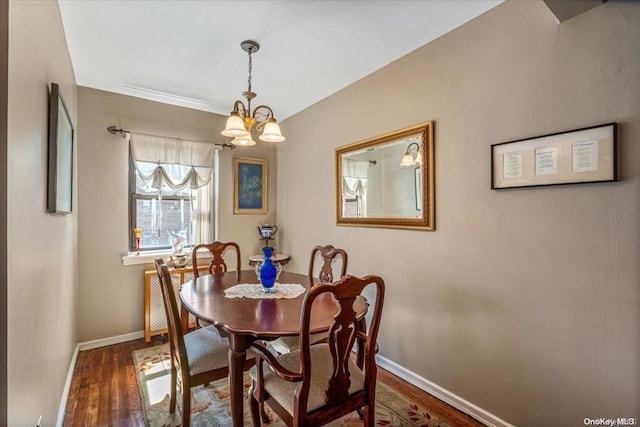 dining area with an inviting chandelier and dark wood-type flooring